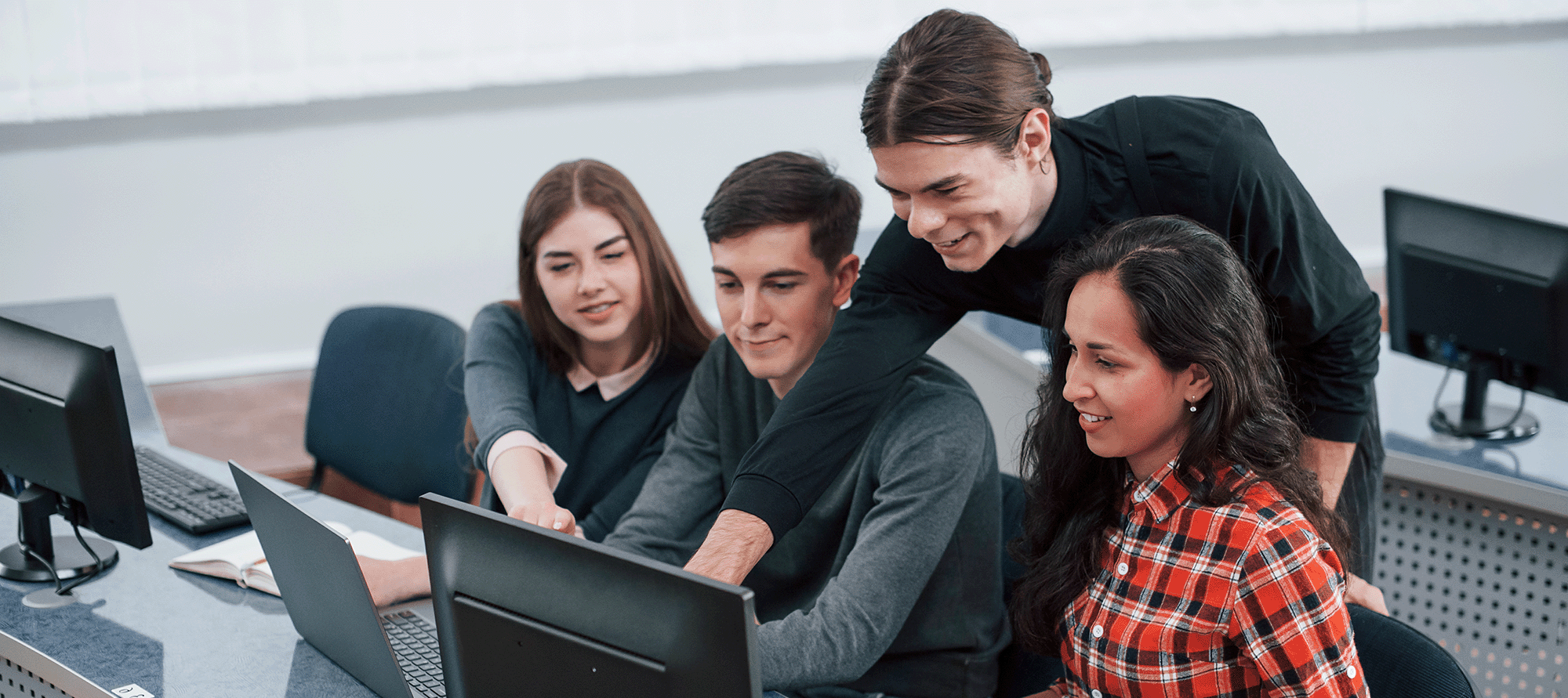 diverse trainer and students on computer desktop