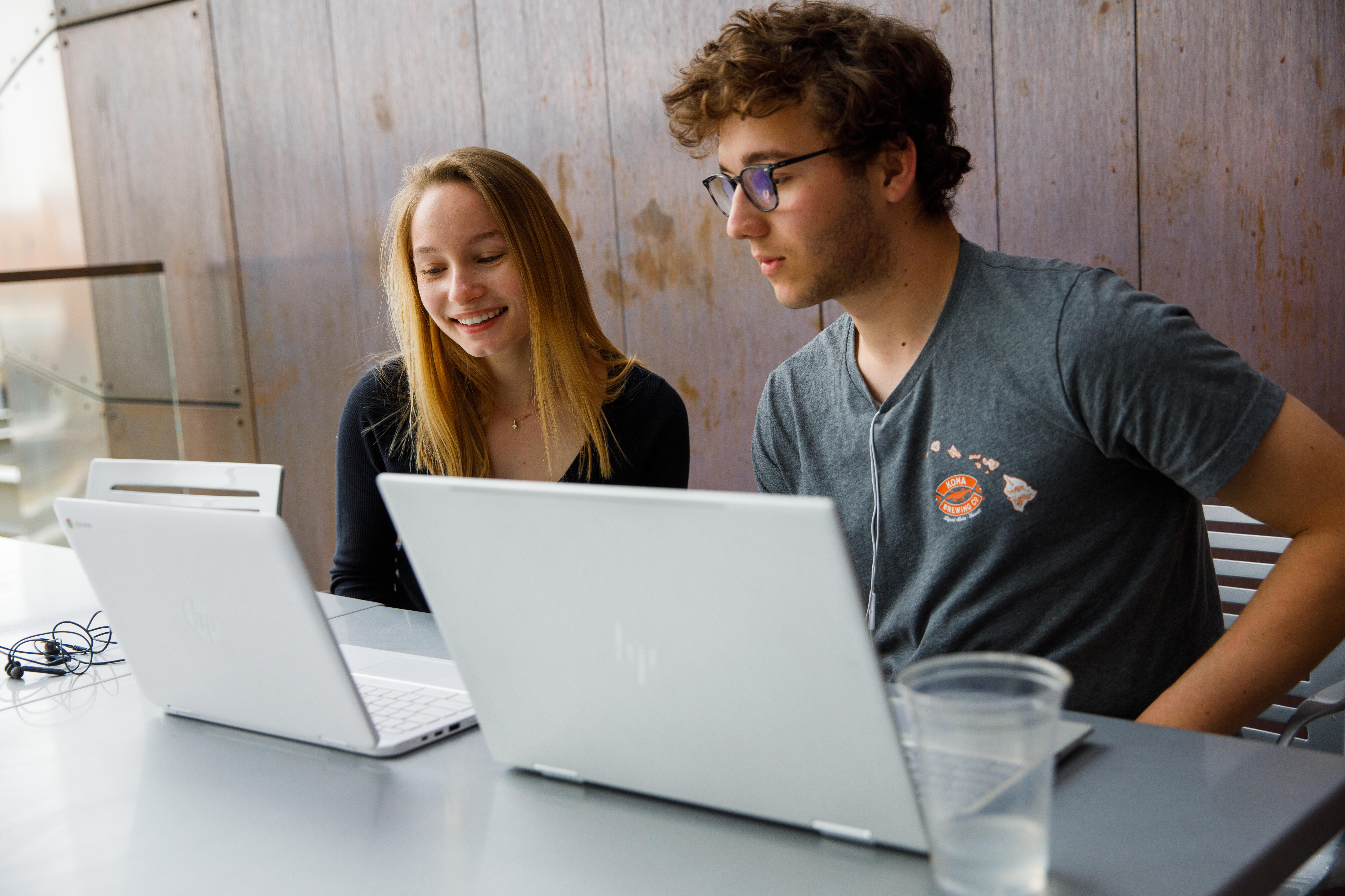 two-students-laptops-working